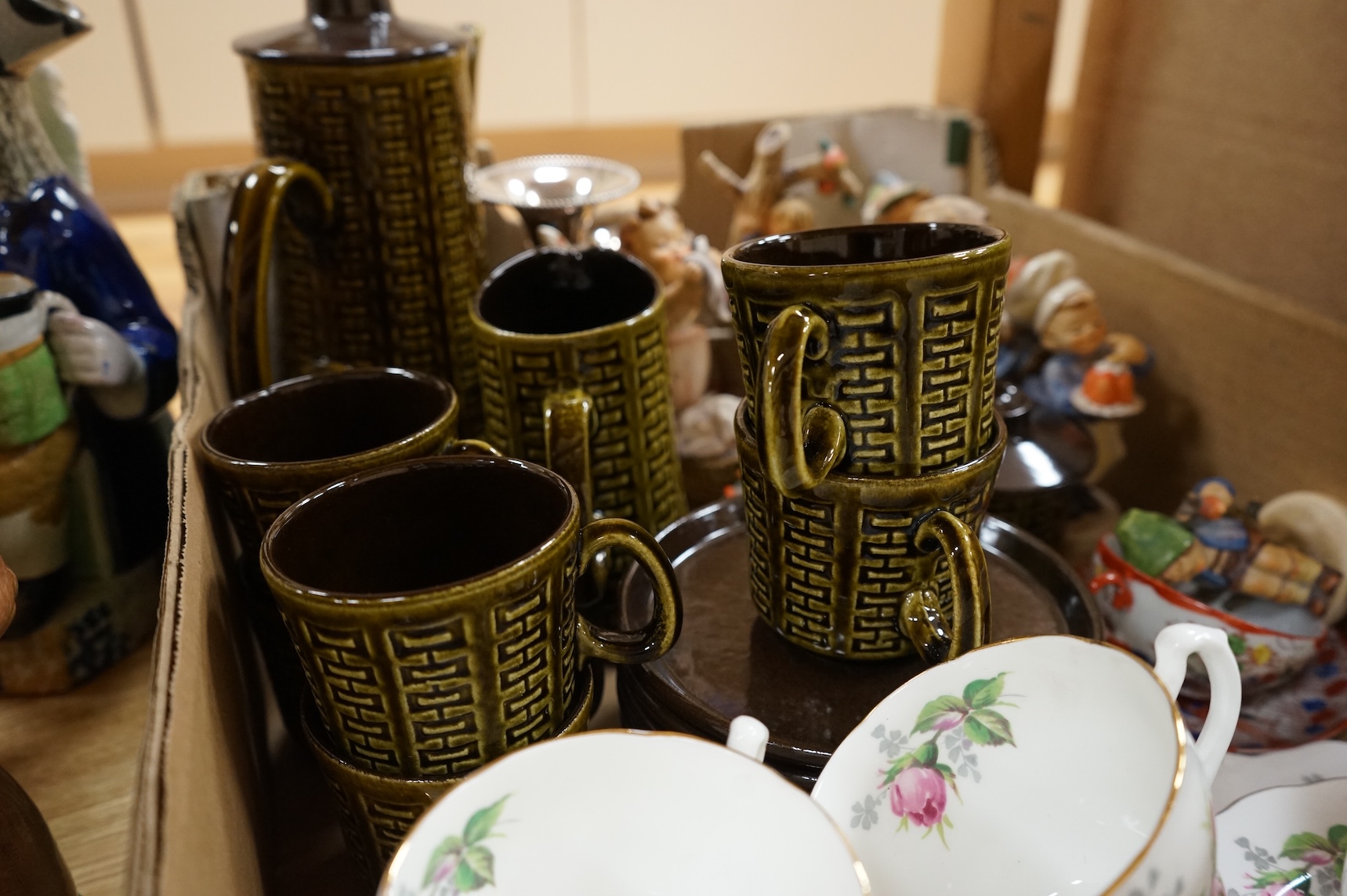 A collection of ceramics to include Doulton Toby jugs, Goebel figurines and Adderley part tea set